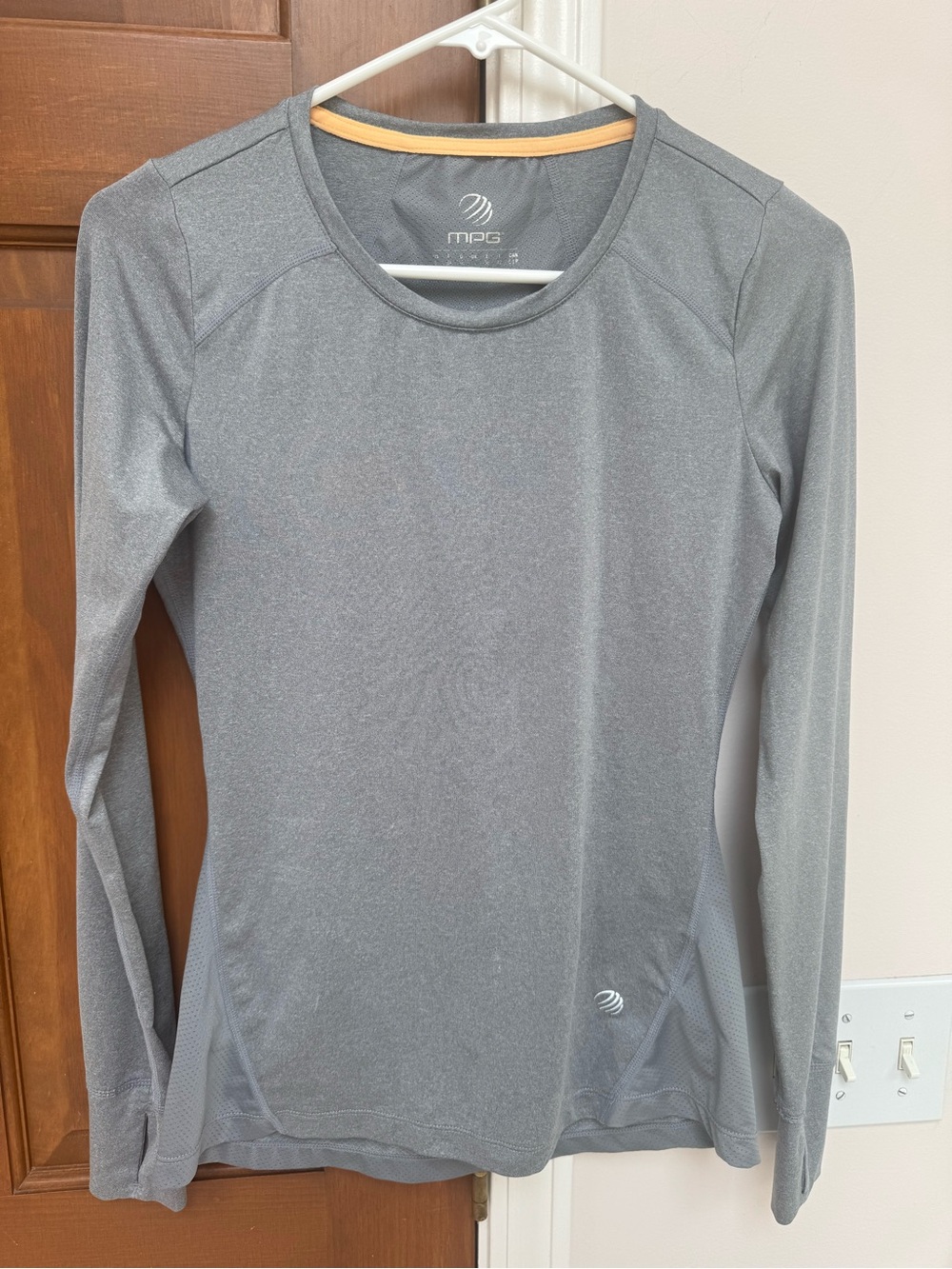gray MPG women's long-sleeve performance top features a crew neck design